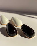 Oversized glossy black teardrop statement stud earrings with gold-tone trim from Lysaire