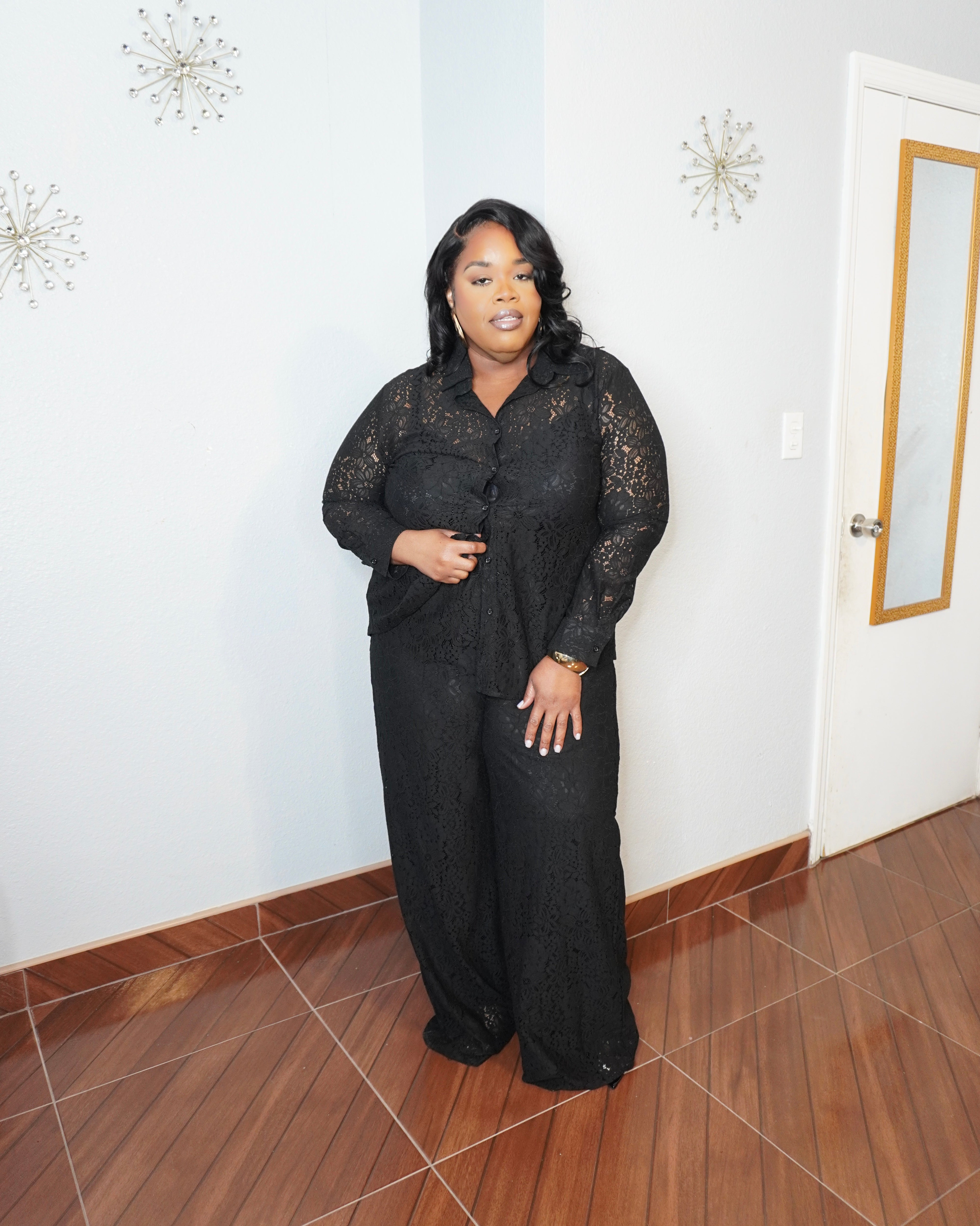 Plus size model wearing black lace pant set with button-down top and wide-leg pants front view elegant outfit