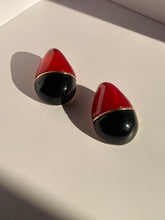Oversized red and black statement stud earrings with glossy finish and gold-tone accent from LYSAIRE