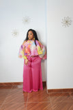 Curvy woman wearing flowy satin pants with elastic waistband and oversized wide leg silhouette