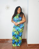 Curvy woman wearing blue green tropical plus size maxi dress