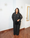 Smiling plus size model in black lace pant set showcasing curve-flattering fit and elegant styling