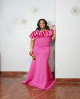 Plus size model wearing elegant pink off shoulder mermaid gown