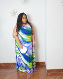 Curvy woman wearing flowy plus size maxi dress with tropical island print