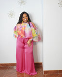 Curvy woman wearing floral cold shoulder blouse from a luxury boutique