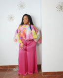 Plus size woman wearing pink watercolor organza statement top with flowing sleeves