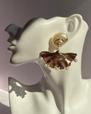 Gold ginkgo leaf fan-shaped statement drop earring with spiral stud and five pearl accents displayed on white mannequin