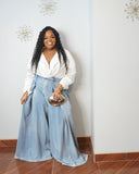 Plus size woman wearing light wash high waist wide leg denim trousers with dramatic voluminous legs