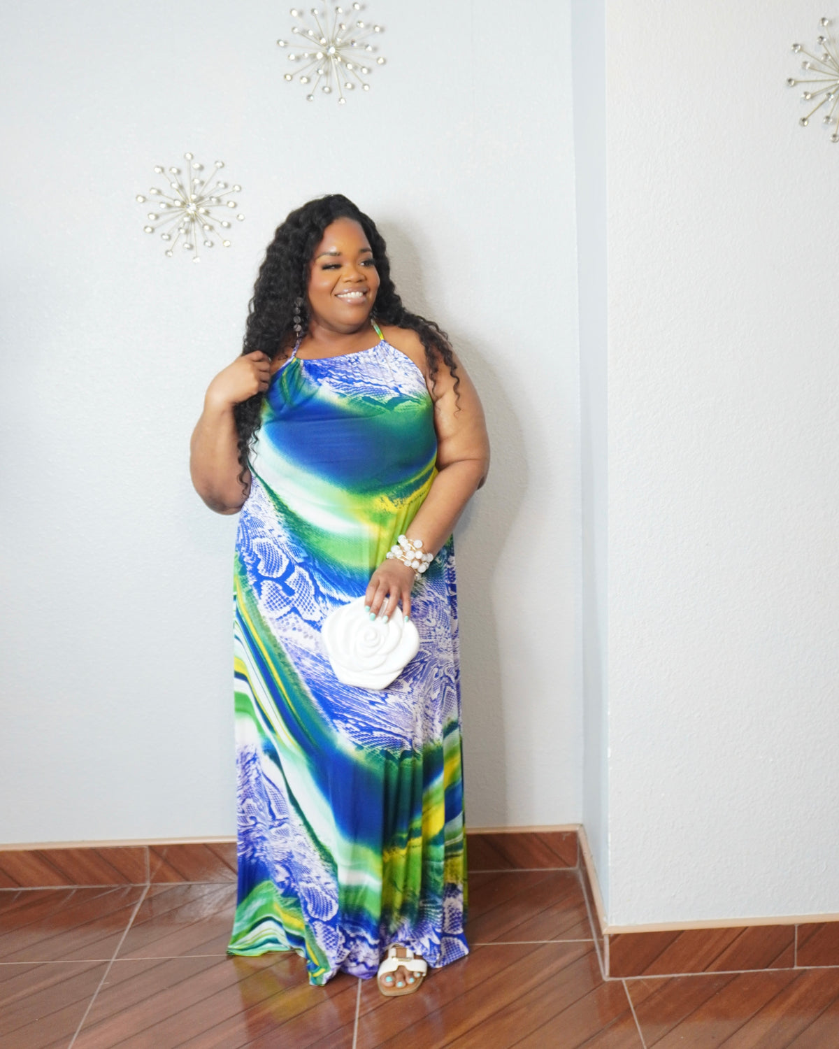 Plus size woman wearing blue and green tropical print maxi dress from a Bahamas boutique
