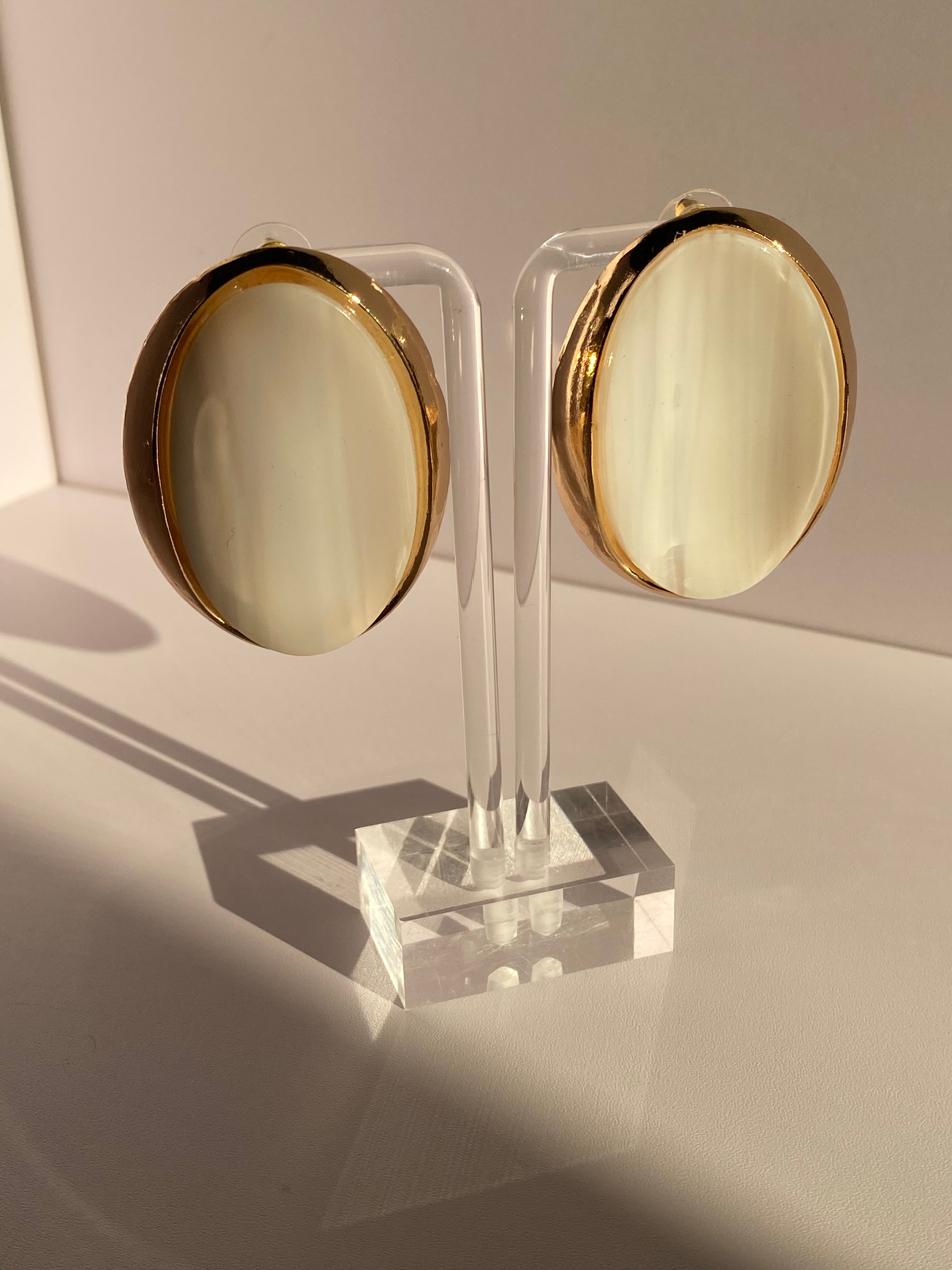 Vintage-inspired oval statement stud earrings with glossy amber orange and cream striped centers and gold-tone borders