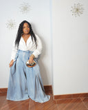 Tall girl friendly plus size wide leg jeans styled with white blouse and metallic clutch