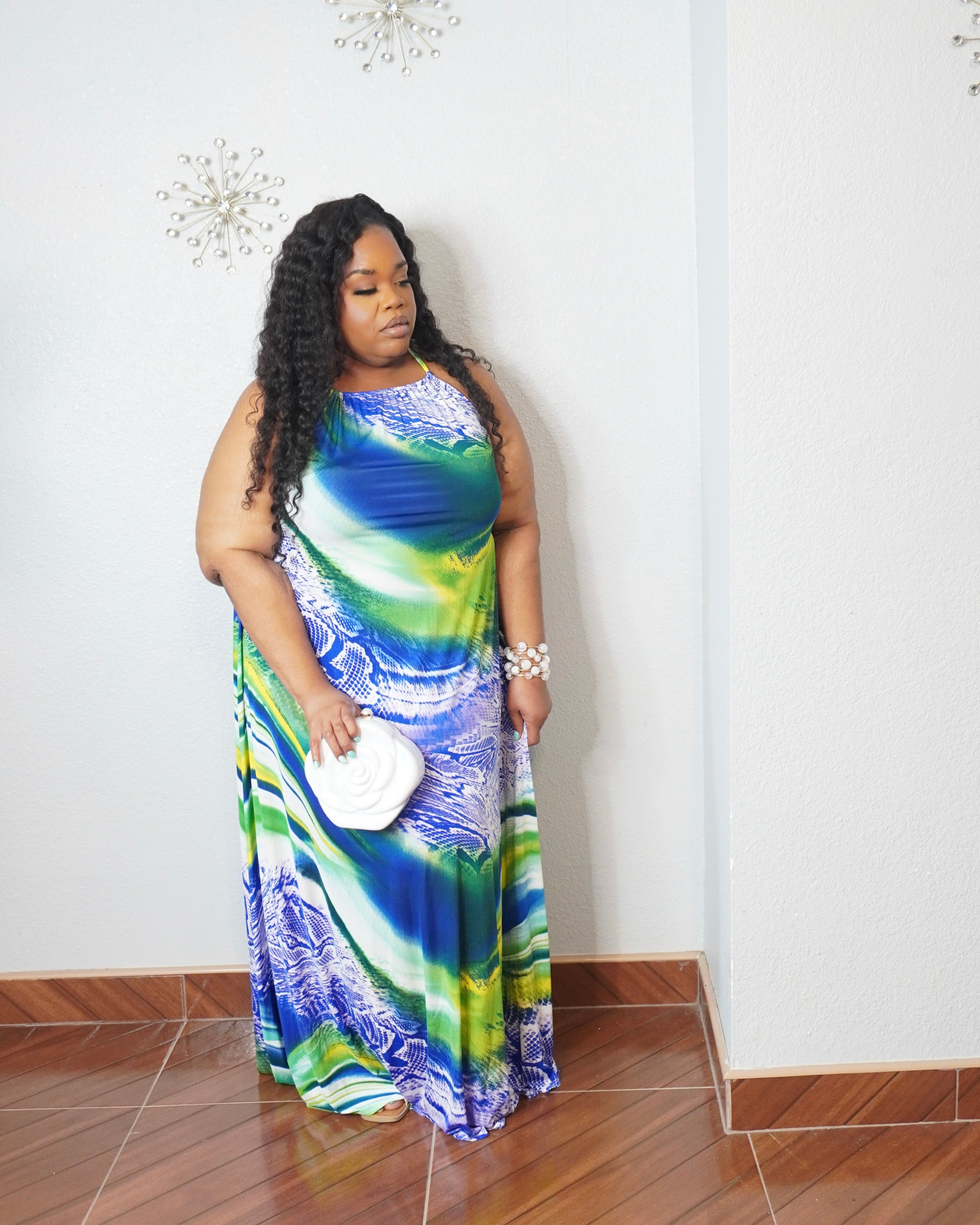 Curvy woman wearing flowy plus size maxi dress with tropical island print