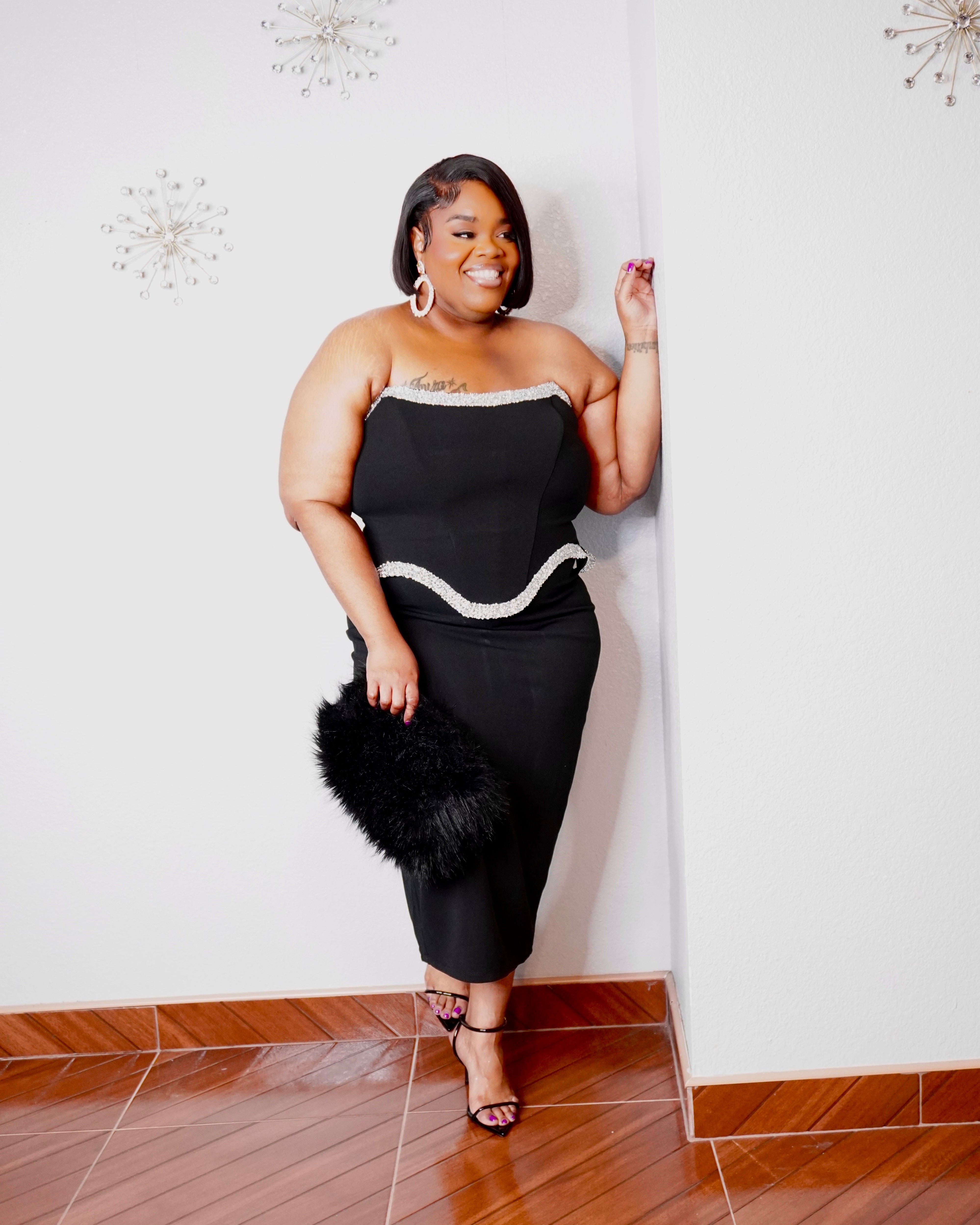 Sophisticated plus-size evening dress with strapless neckline, crystal-style trim, and fitted silhouette.