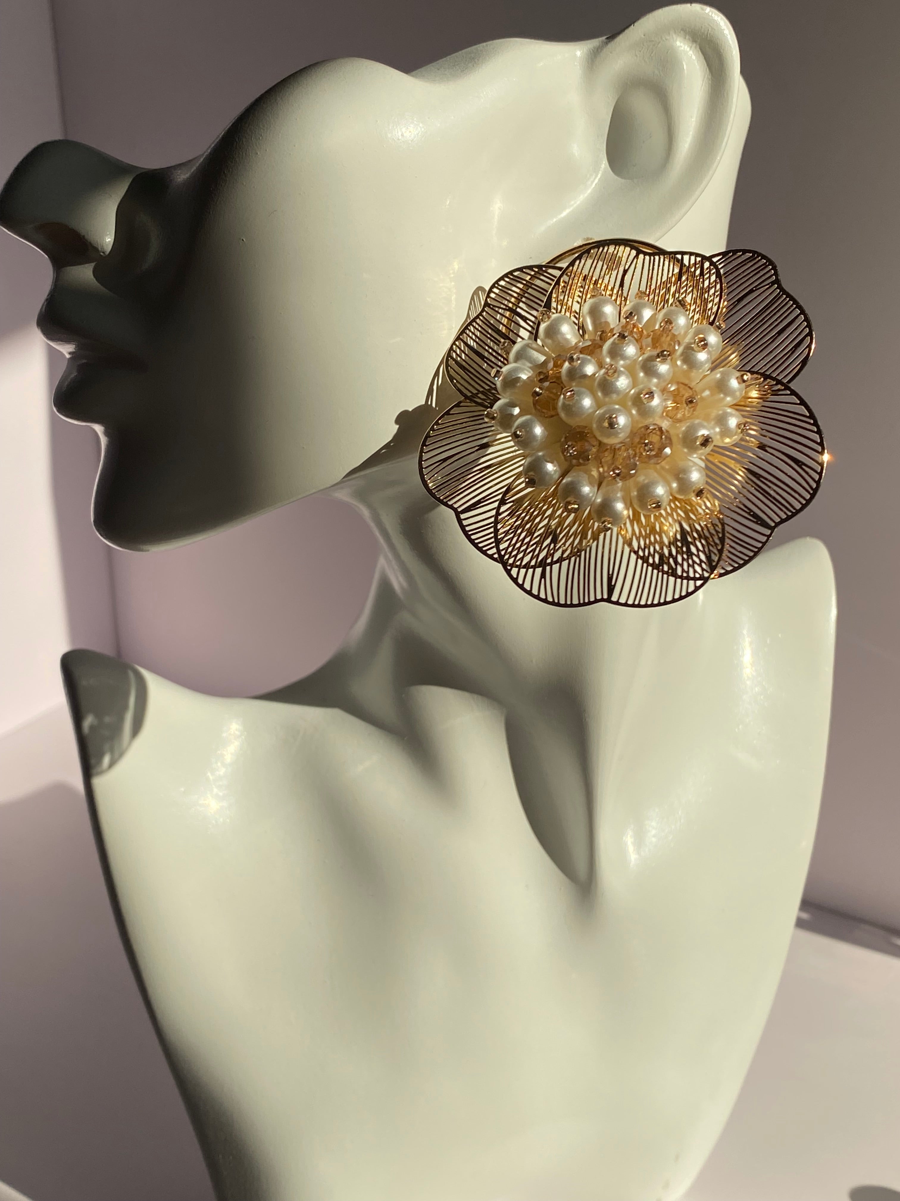 Gold flower statement earring featuring delicate wirework petals and dimensional ivory pearl-like accents