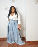 Plus size statement denim trousers with cinched waist and dramatic volume through hips and thighs