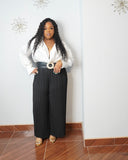 Plus size black pleated trousers styled for an elevated occasion look