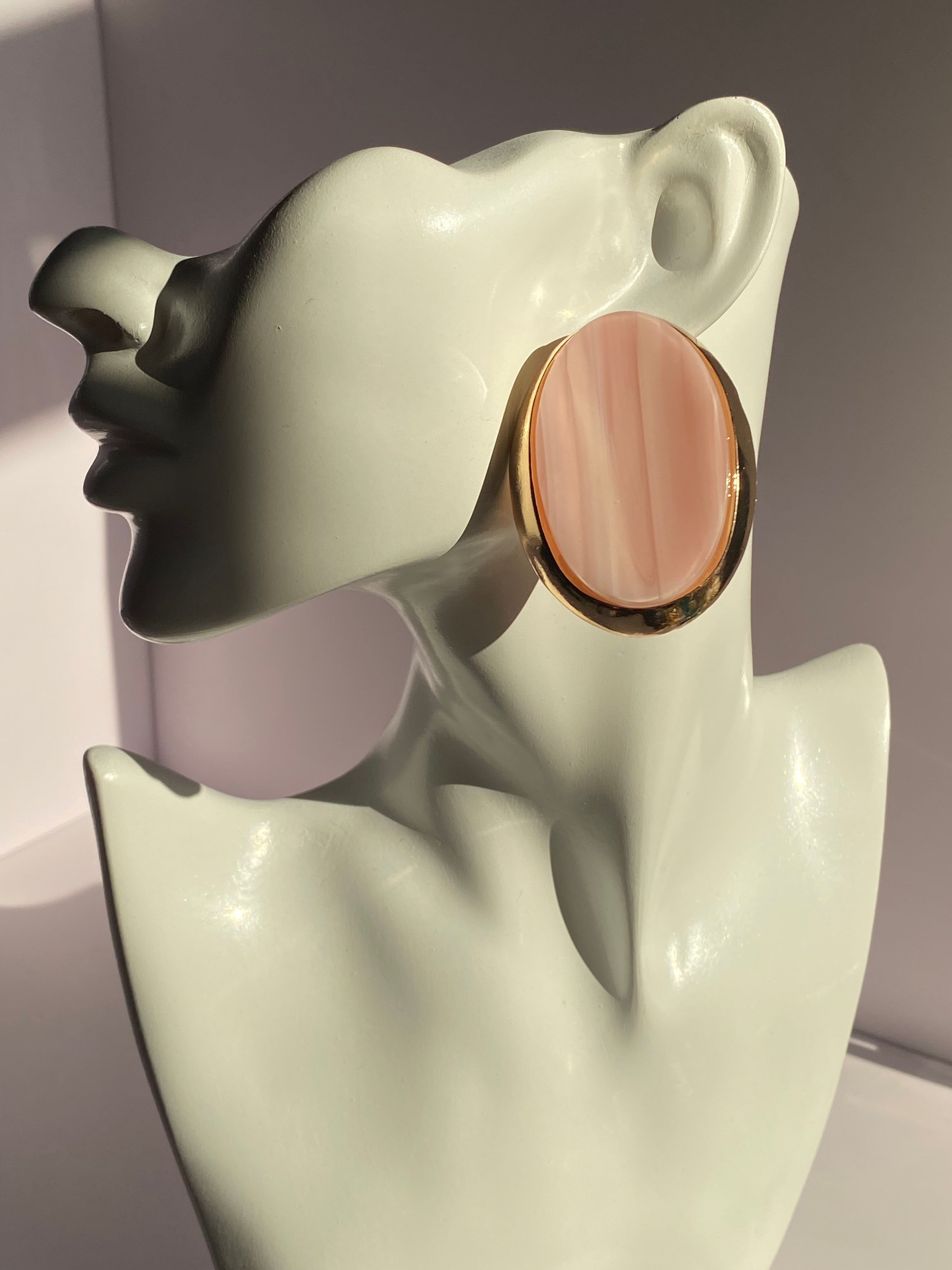 Vintage-inspired oval statement stud earrings with glossy amber orange and cream striped centers and gold-tone borders
